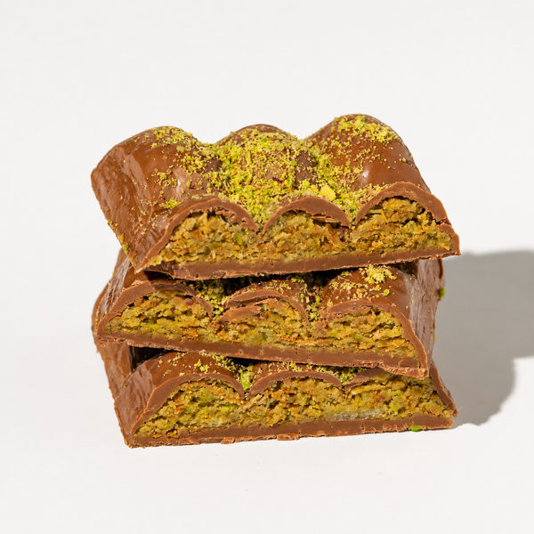 Delicious Dubai Chocolate Baklava by Nuts Factory, featuring rich chocolate and flaky pastry layers on a white plate.