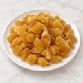 Dried low-sugar ginger slices from Nuts Factory, showcasing their natural golden color and textured surface for healthy snacking.